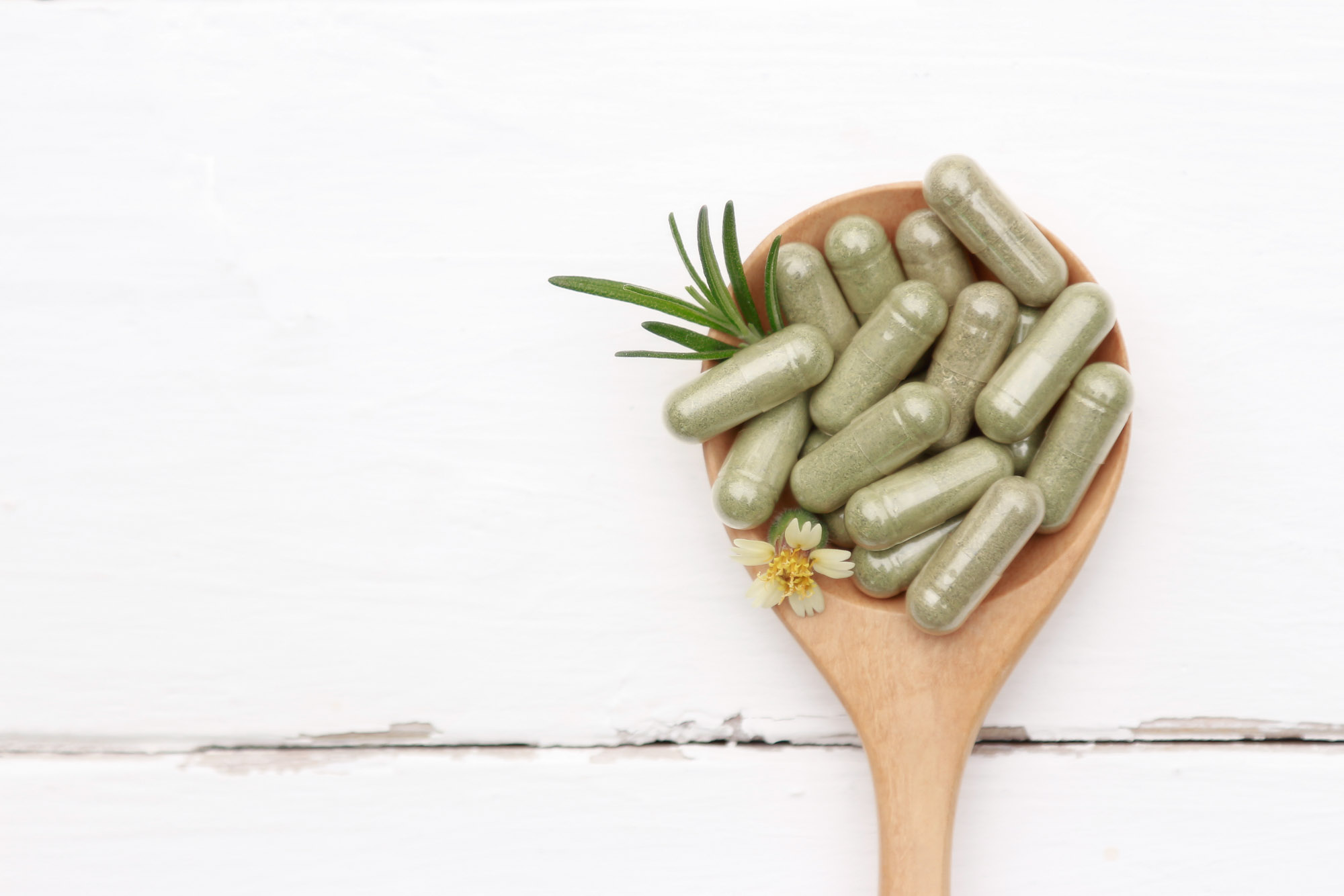 herbal medicine in wooden spoon
